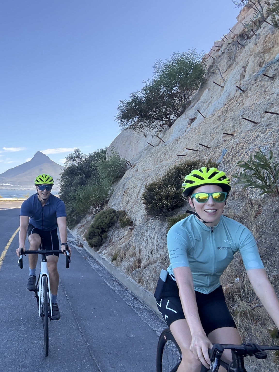 Two guests enjoying a guided Cape Town ride with Lion’s Head behind them